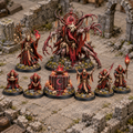 Eight miniatures from the Blood Moon Ritual set arranged on a ruined tabletop.