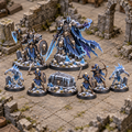 Eight miniatures from the Frozen Tomb encounter set arranged on a ruined tabletop.