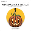 Illustration: the winking jack pumpkin keychain hanging from its cord in front of a yellow circle