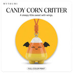 Illustration: the candy corn critter keychain hanging from its cord in front of a yellow circle