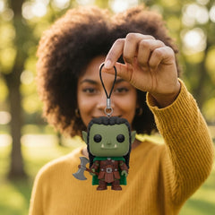 Illustration: a person holding up their orc warrior block-head keychain by its cord