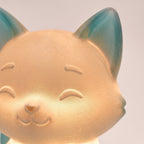 Illustration: close-up of the fox night light's face, showing the teal shimmer PLA and warm glow