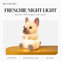 Illustration: the French bulldog night light glowing on a yellow platform under the MYTHUMI headline