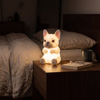 Illustration: the French bulldog night light glowing at night in a bedroom on a walnut bedside table