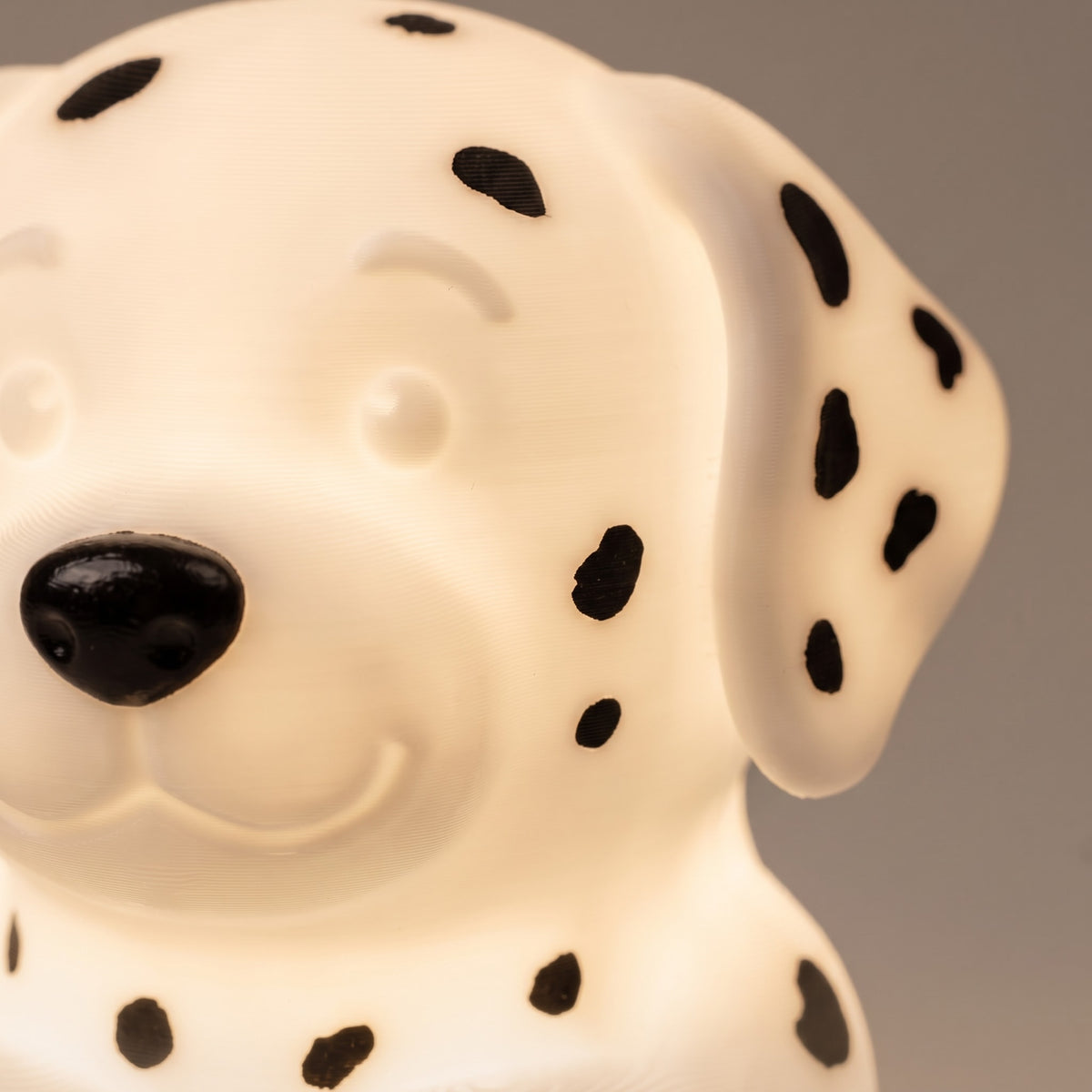 Illustration: close-up of the Dalmatian night light's face, black nose and spots