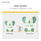 Illustration: size guide showing the elephant night light at 23 cm and 33 cm tall beside a coffee mug