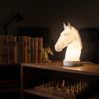 Illustration: the horse head lamp glowing at night in a home office on a bookshelf above a chessboard