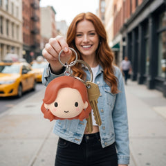 Illustration: a person holding up keys with their minimal soft chibi face keychain attached