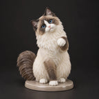 Ragdoll Cat figurine in paw up pose, studio view
