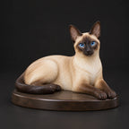 Siamese Cat figurine in lying relaxed pose, studio view
